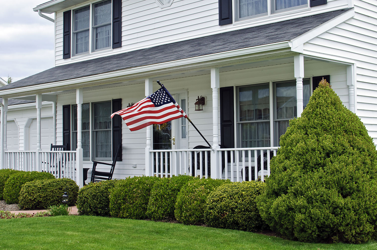 American Flag flying in front of house