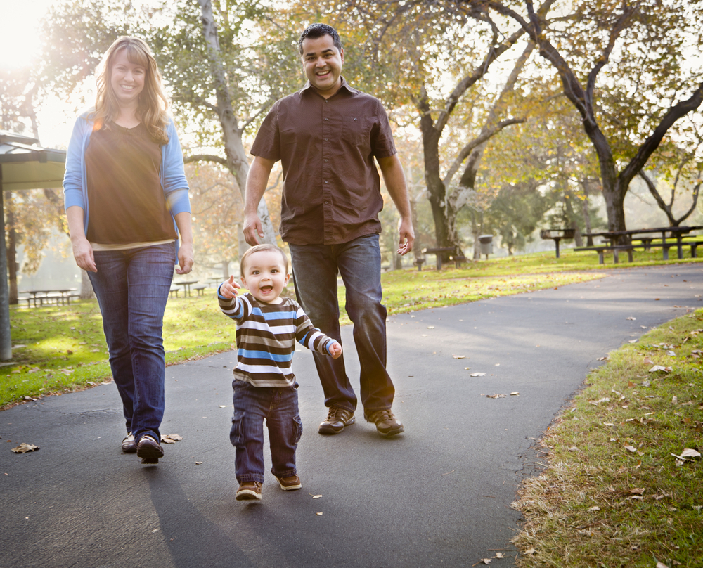 Couple and toddler walking on path