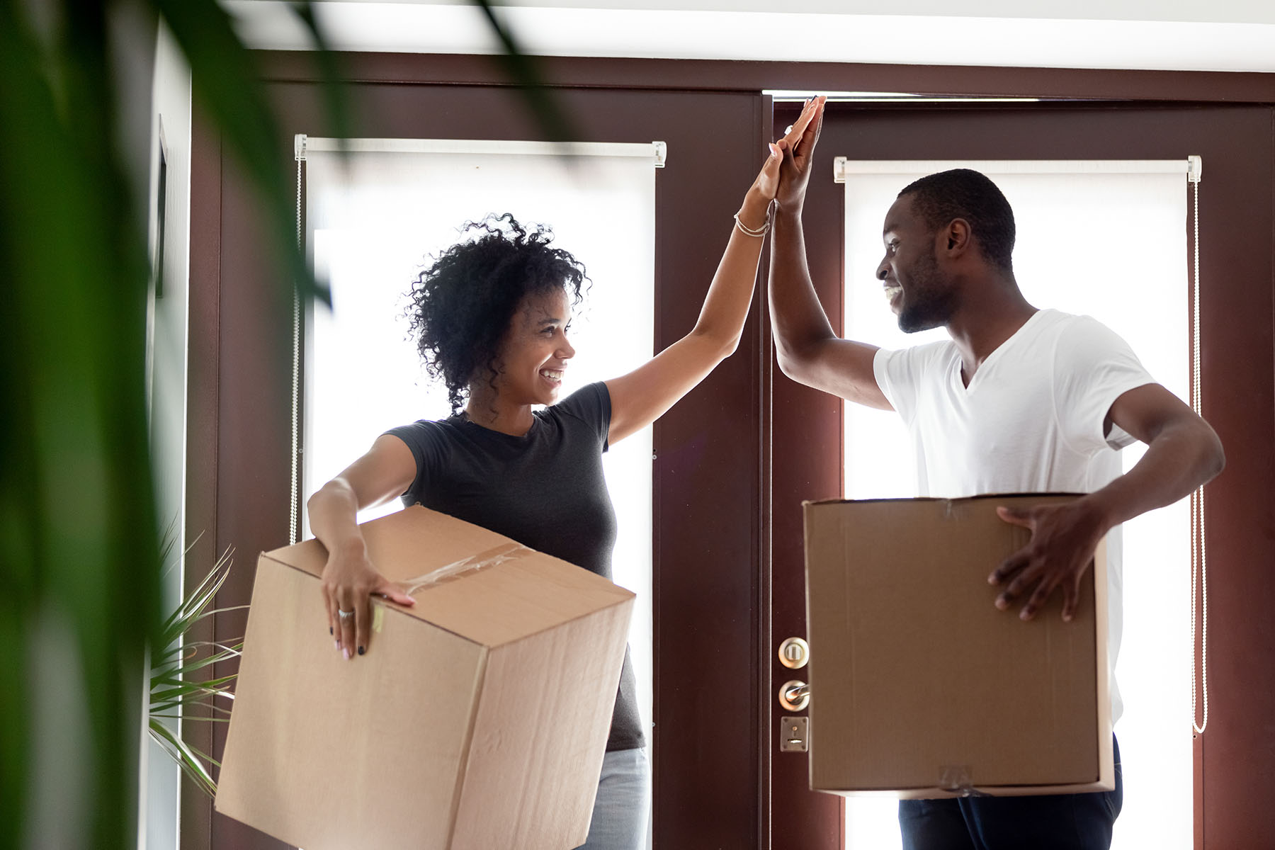 Couple in front door with boxes